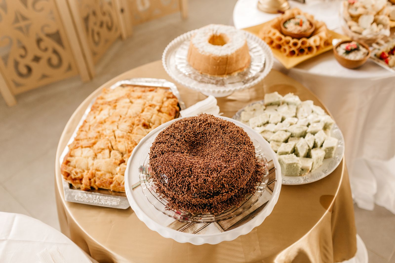 An array of delicious desserts elegantly presented on round tables. Perfect for celebrations or events.