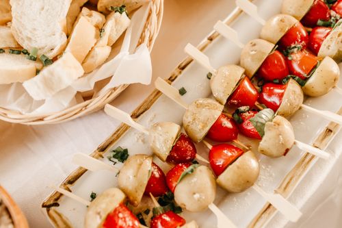 Free Vegan skewers featuring potatoes and tomatoes, perfect for appetizers. Stock Photo