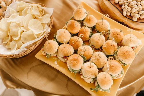 Free A tempting arrangement of mini sandwiches served with potato chips, perfect for a party or casual gathering. Stock Photo