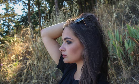 Portrait of a woman posing with sunglasses, set against Ohrid's natural backdrop.