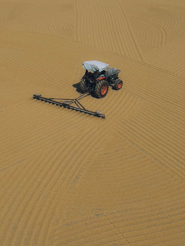 Tractor Creating Wavy Pattern On Sand