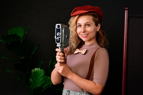 Woman in Hat Holding Vintage Camera