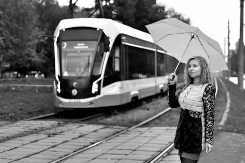 Grayscale Photo of a Woman Holding an Umbrella