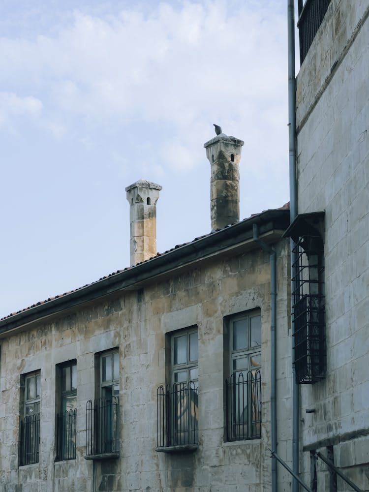 Old Concrete Building With Balconies Under White Sky