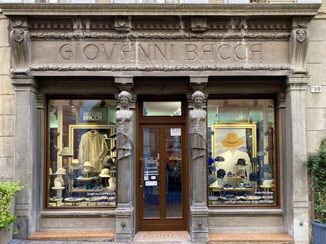 Classical hat store entrance in Rovereto with detailed facade and stylish window displays.