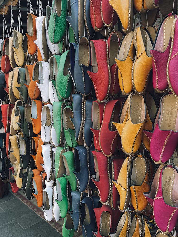 Handmade Leather Shoes Hanging On A Market Stall 