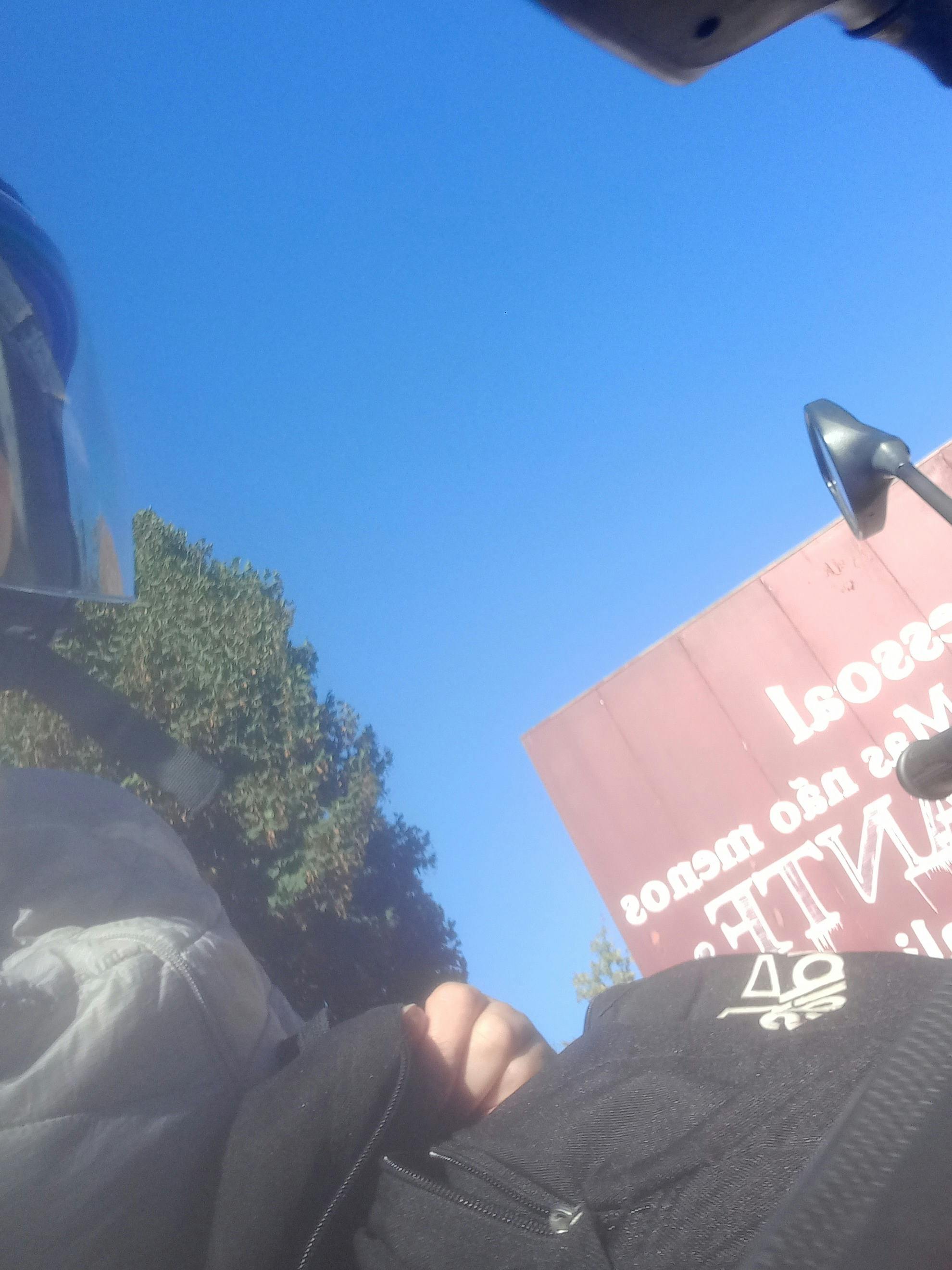 F1 driver racing at high speed down a straight with another car in pursuit