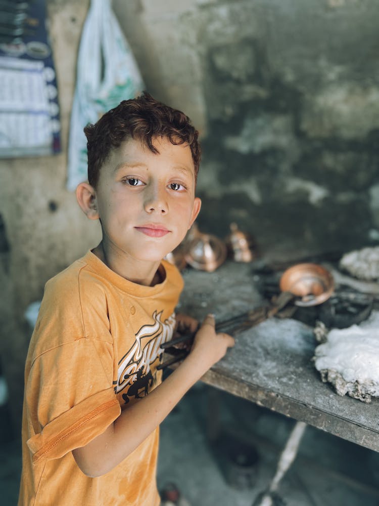 A Boy Holding A Metal