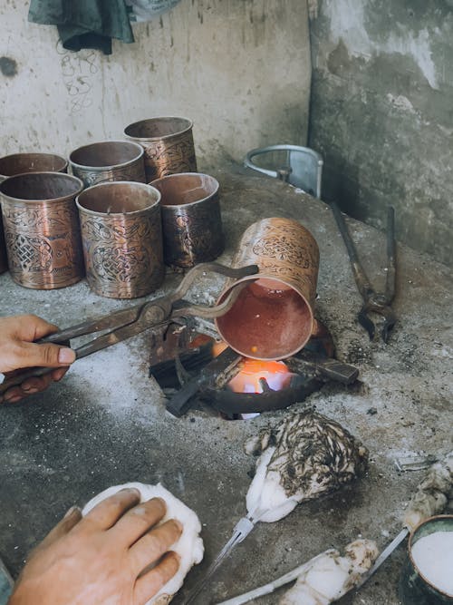 Blacksmith Working with Metal Pot