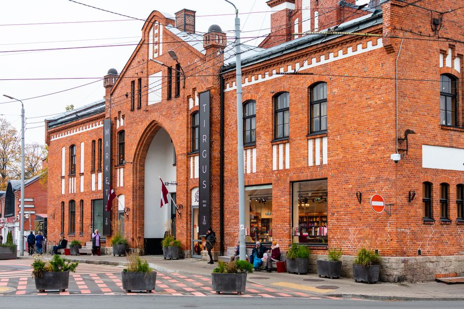 Lively street view in Riga's Centrs district, Latvia, showcasing buildings and local activity.