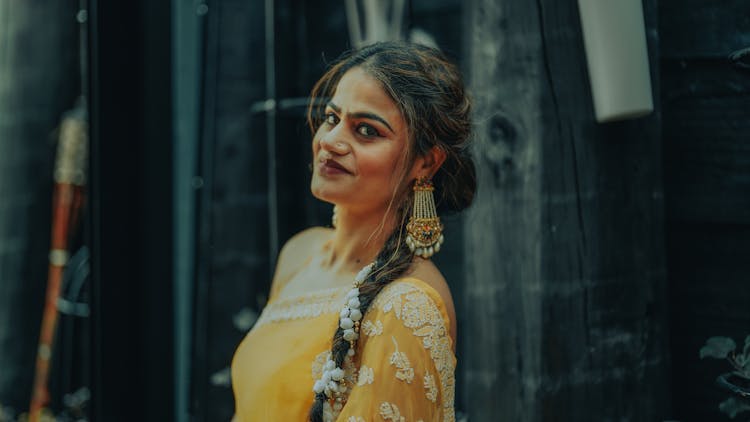 Woman In Yellow Dress With Floral Embroidery