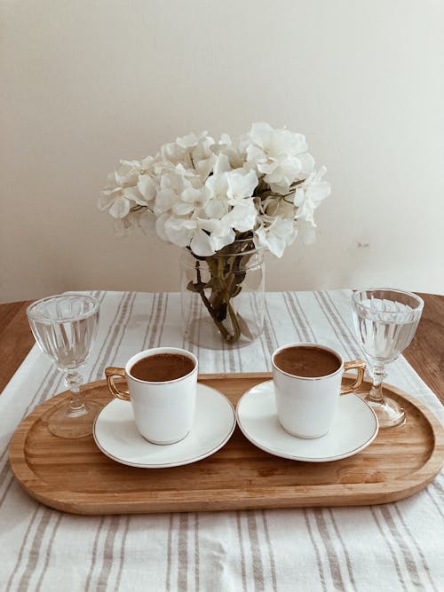 Two Cups of Coffee and Glasses of Water on a Wooden Tray