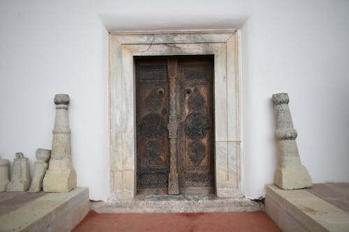 Antique Wooden Door on White Concrete Wall