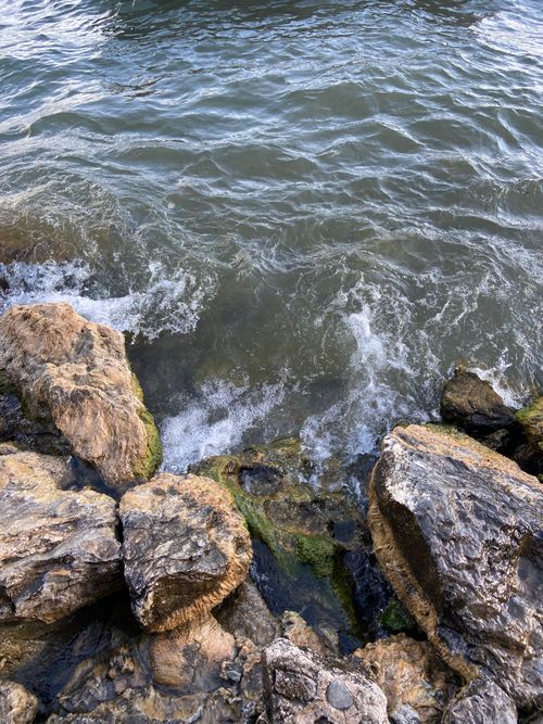 Free Captivating scene of ocean waves crashing against rugged rocky shore, showcasing nature's power. Stock Photo