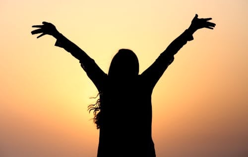 Silhouette Girl While Raising Hands