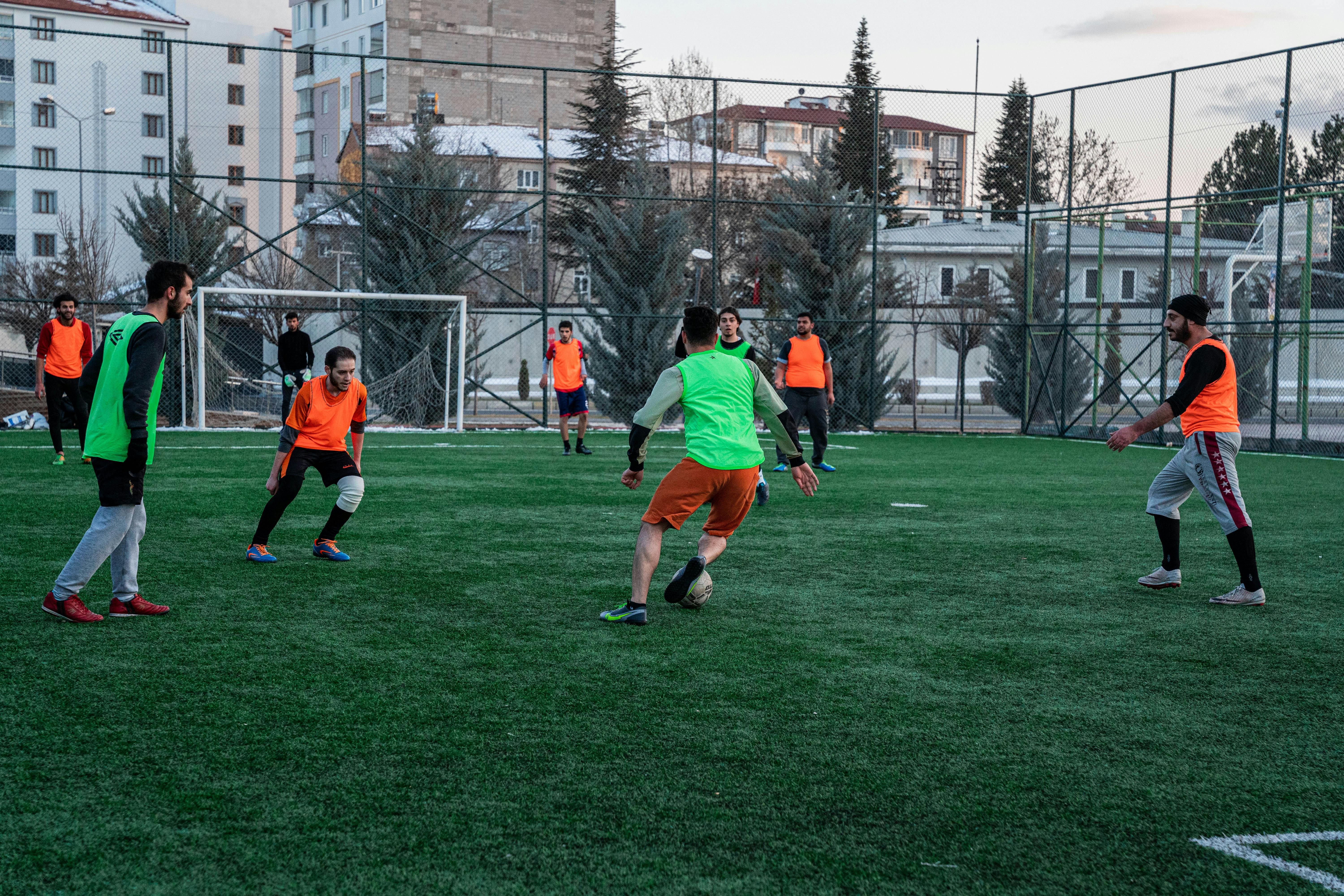 men playing soccer in the sportsground