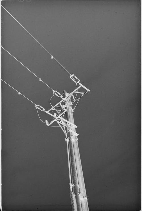 Grayscale Photo of Electric Post