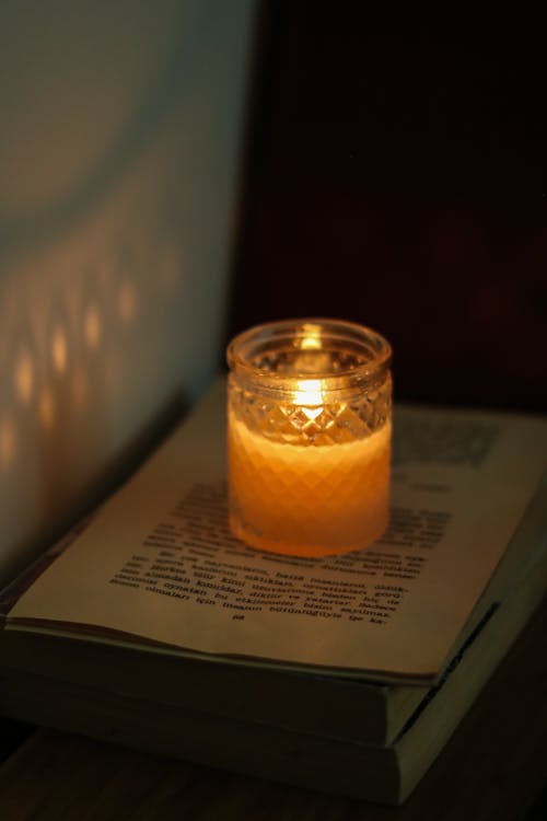 Lighted Candle on Top of a Book