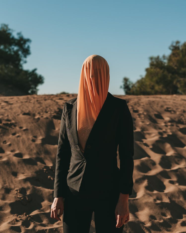 Person With Cloth Covering Head In A Black Blazer