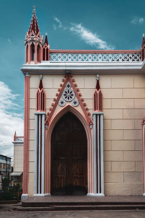 Free Gothic Revival church facade with intricate designs in Mérida, Venezuela, under a vibrant sky. Stock Photo
