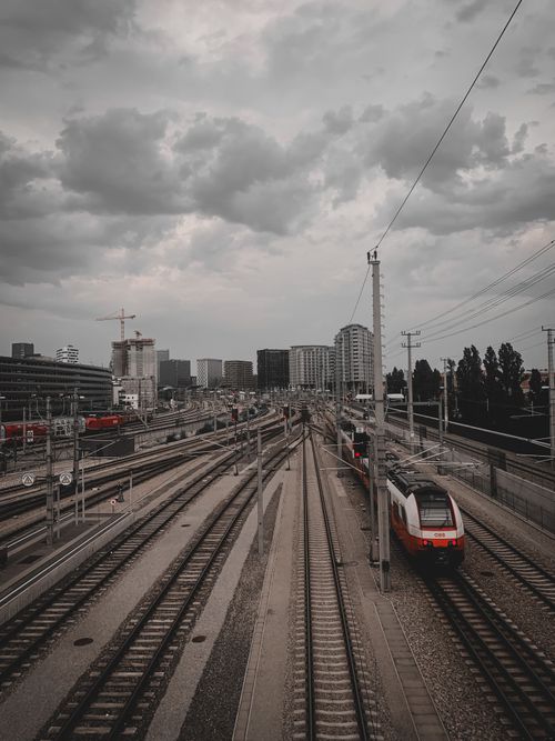 Free Aerial view of railway tracks and trains within an urban cityscape in Vienna, Austria. Stock Photo