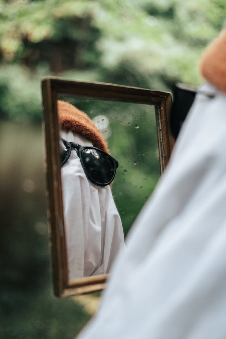 Man Dressed Up As Ghost Looking In The Mirror