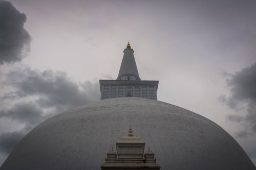 Free Majestic low angle view of the Ruwanweli Maha Seya Stupa under cloudy skies in Sri Lanka. Stock Photo