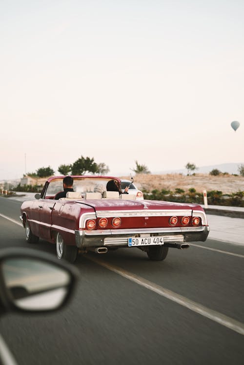 Retro Car Driving on Road 