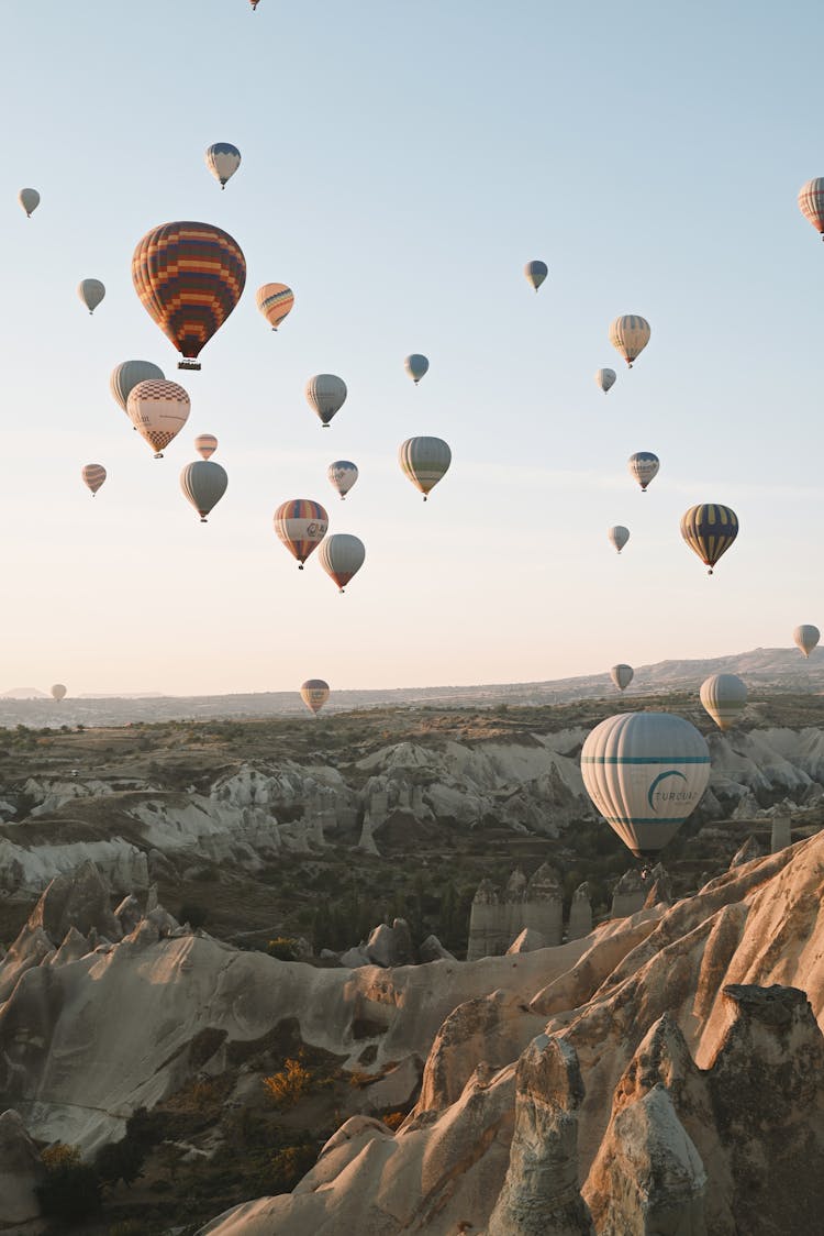 Hot Air Balloons In Sky Above Mountains