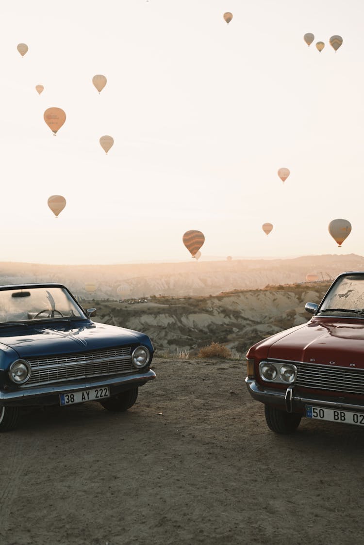 Vintage Cars In Landscape With Hot Air Balloons