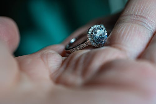 Diamond Studded Ring on a Person's Hand