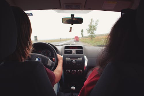 Two Woman Sitting Inside Vehicle 