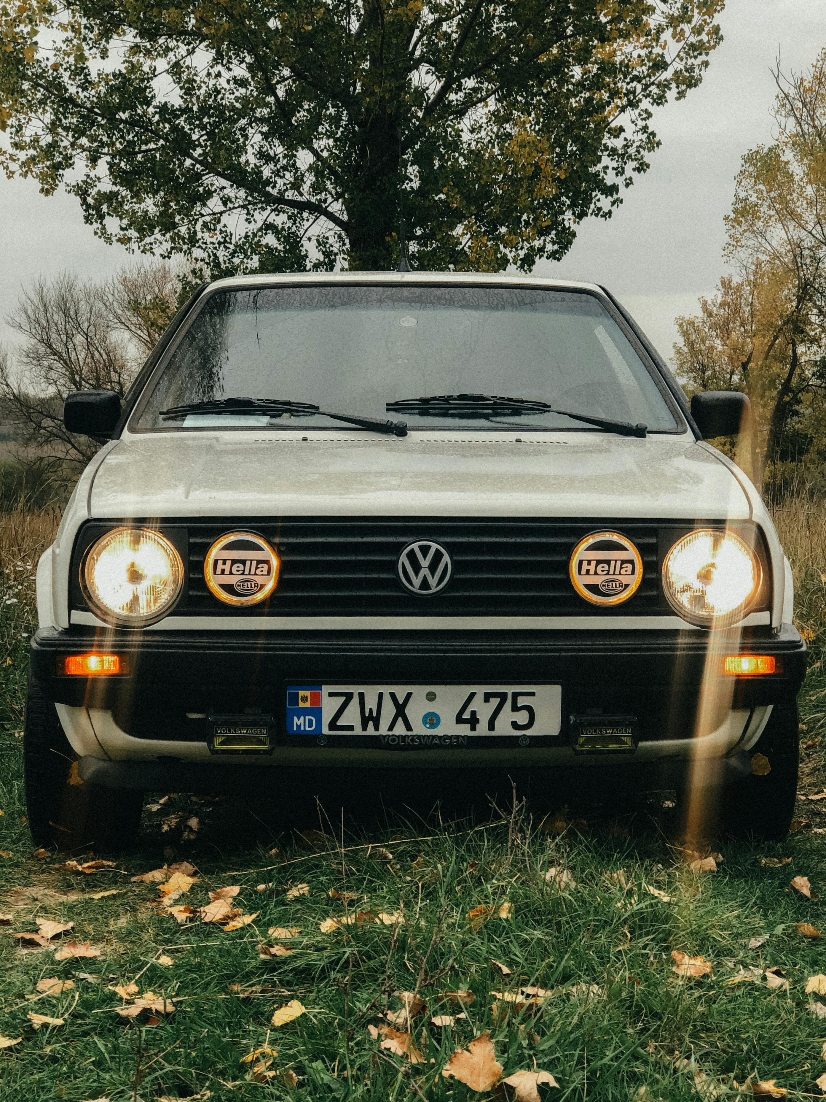 Classic Volkswagen car captured in a rustic autumn setting, evoking nostalgia.