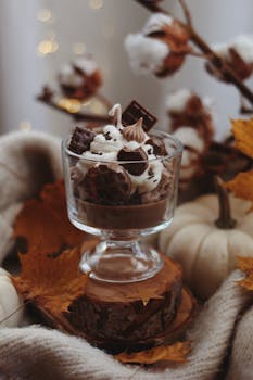 Delicious autumn dessert with chocolate and whipped cream, surrounded by pumpkins and leaves.
