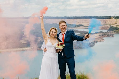 Bride And Groom Holding Smoke Bombs