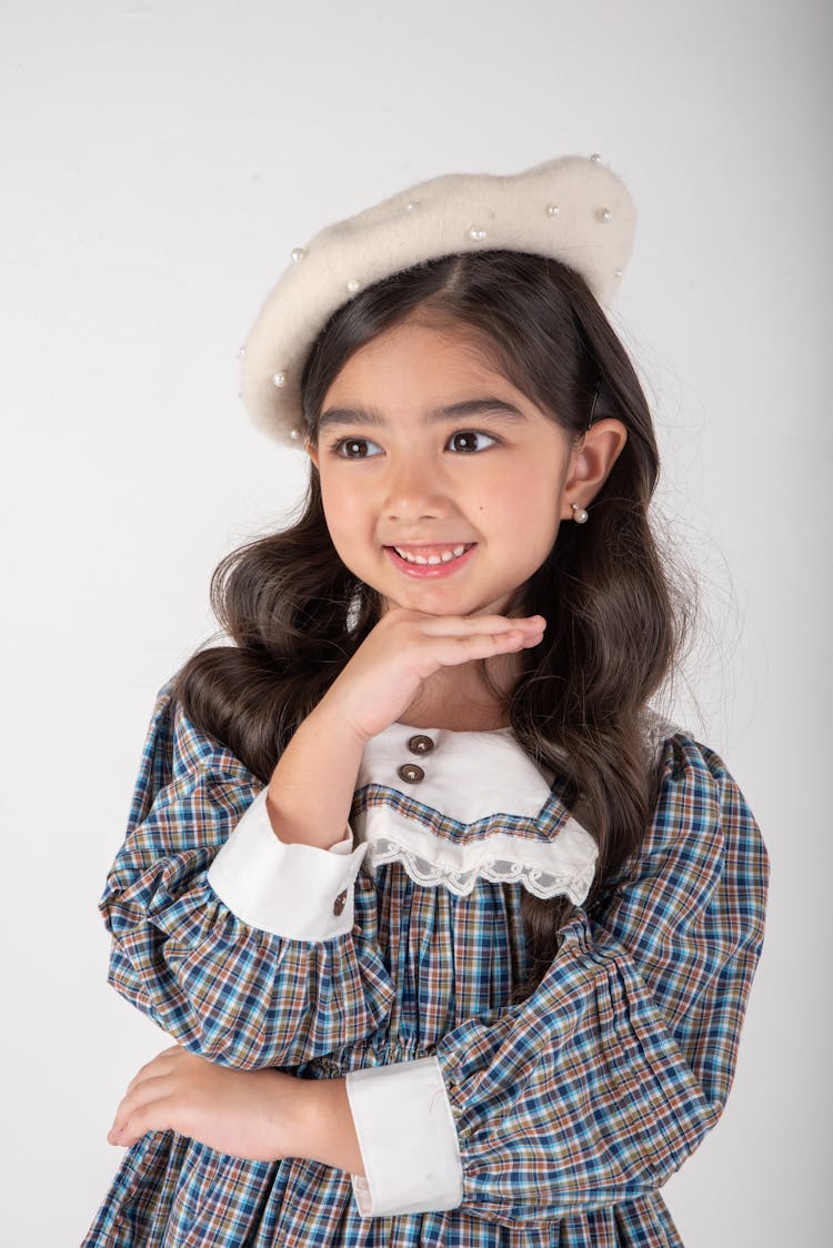 Pretty Little Girl In Plaid Dress Posing