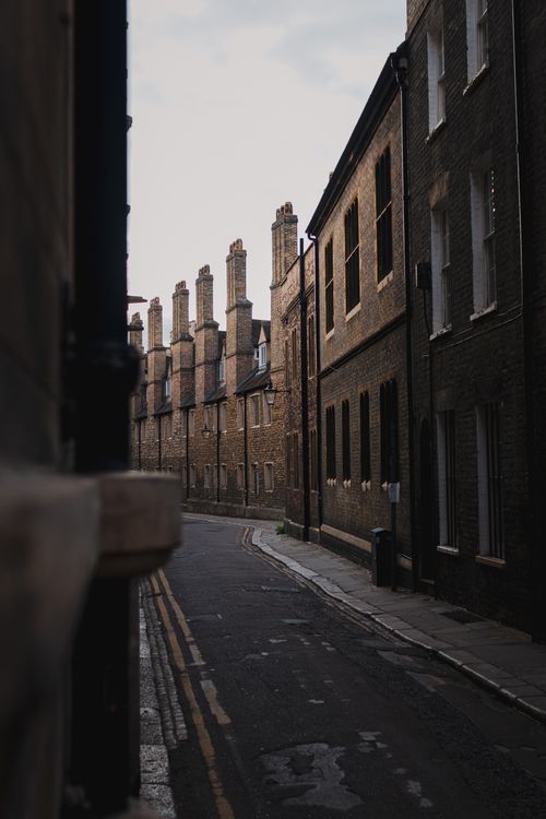 Free Explore the timeless architecture of a narrow, historic street in Cambridge, UK. Stock Photo