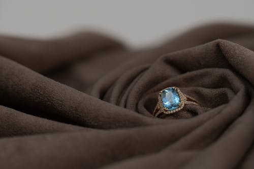 A Ring with Gemstone on a Brown Fabric