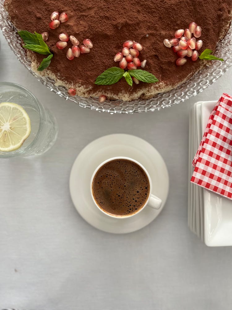 Cake With Pomegranate Seeds And Mint Leaves