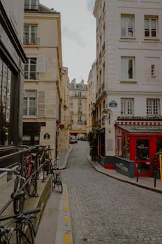 A quaint cobblestone street in Paris, lined with bicycles and charming architecture.