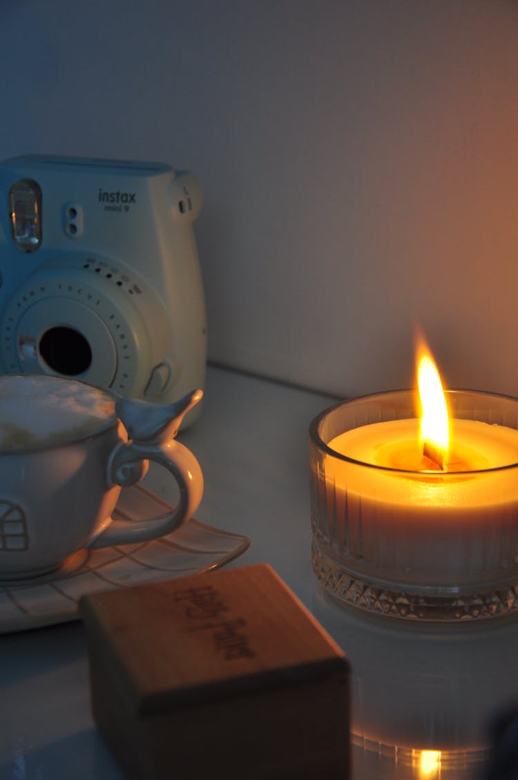 Lighted Candle On A Glass Container