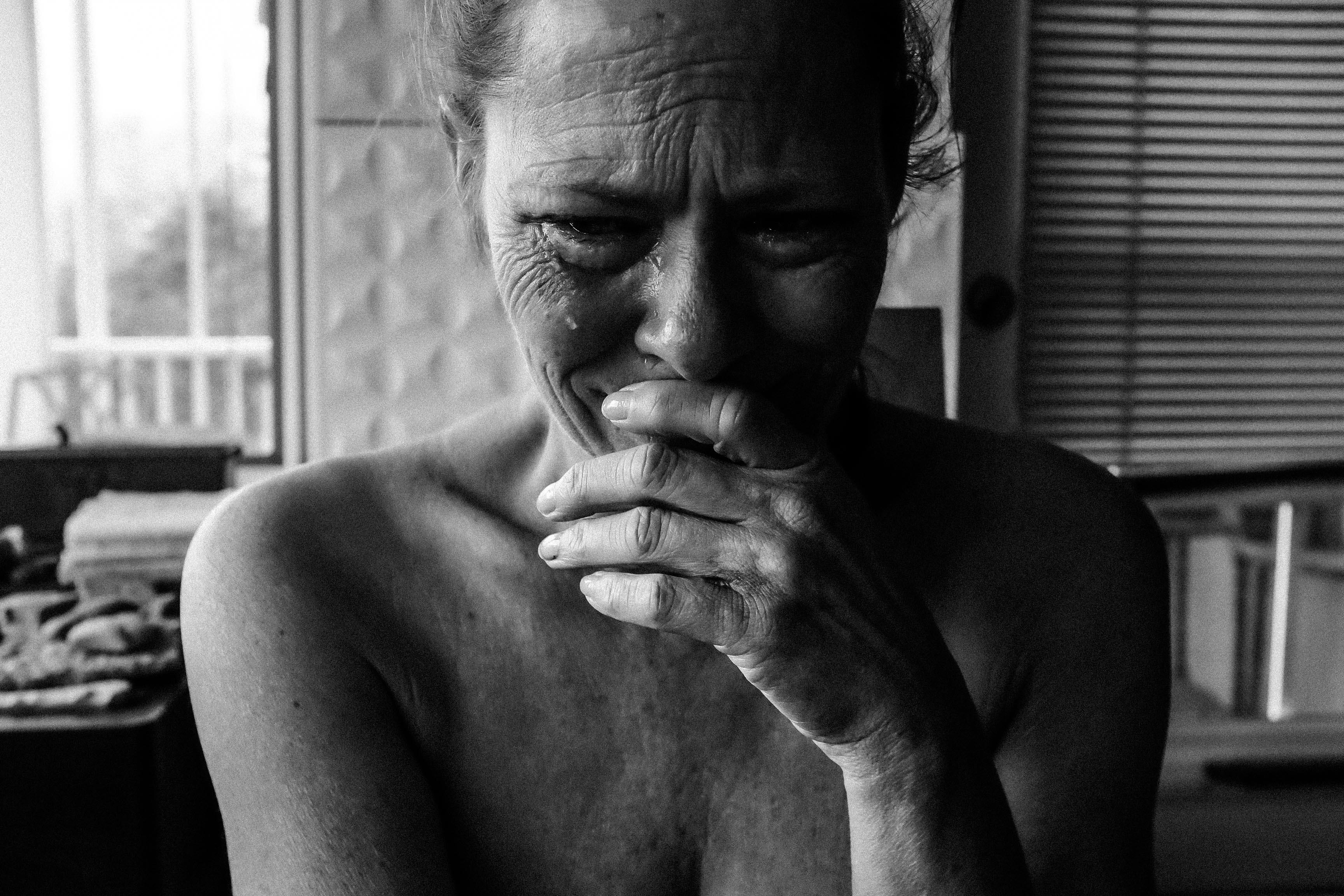 Close-up Photography of Crying Woman Next Inside Room
