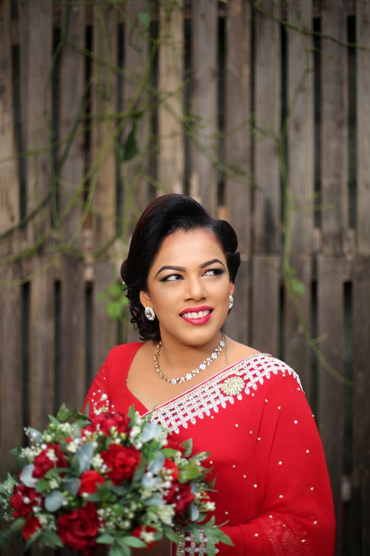 Smiling Woman In Red Sari Looking Sideways