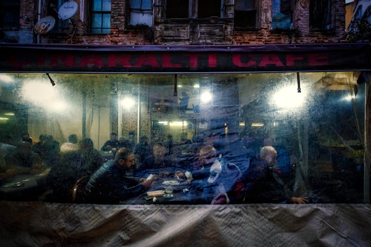 Facade Of A Cafe And People Indoors Seen Through The Window 