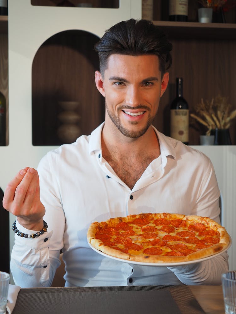 Man In White Long Sleeves Holding A Pizza