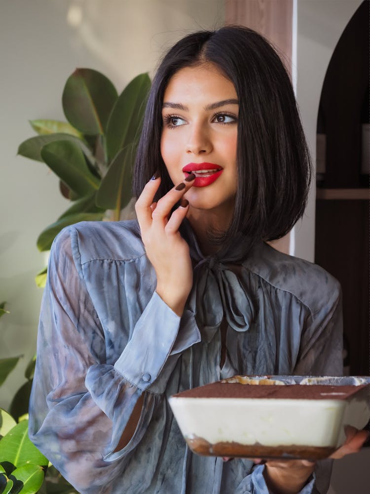 Young Beautiful Woman Tasting A Chocolate Dessert From A Pan