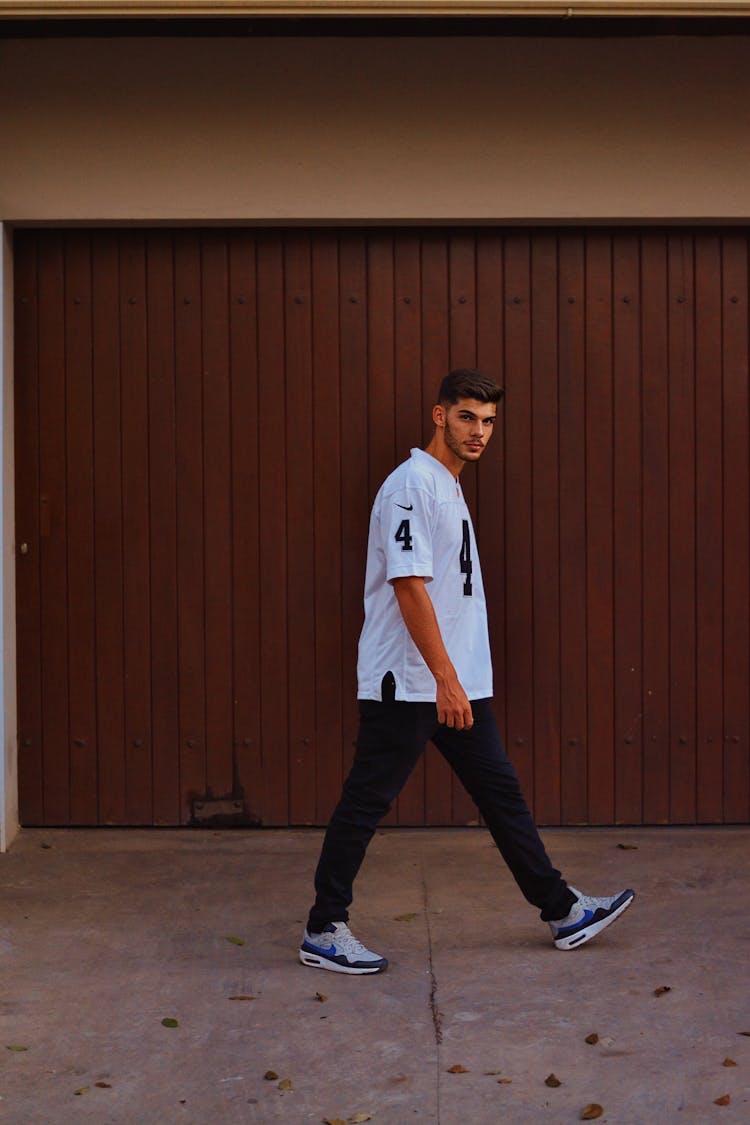 Man Wearing T-shirt Walking Near Garage