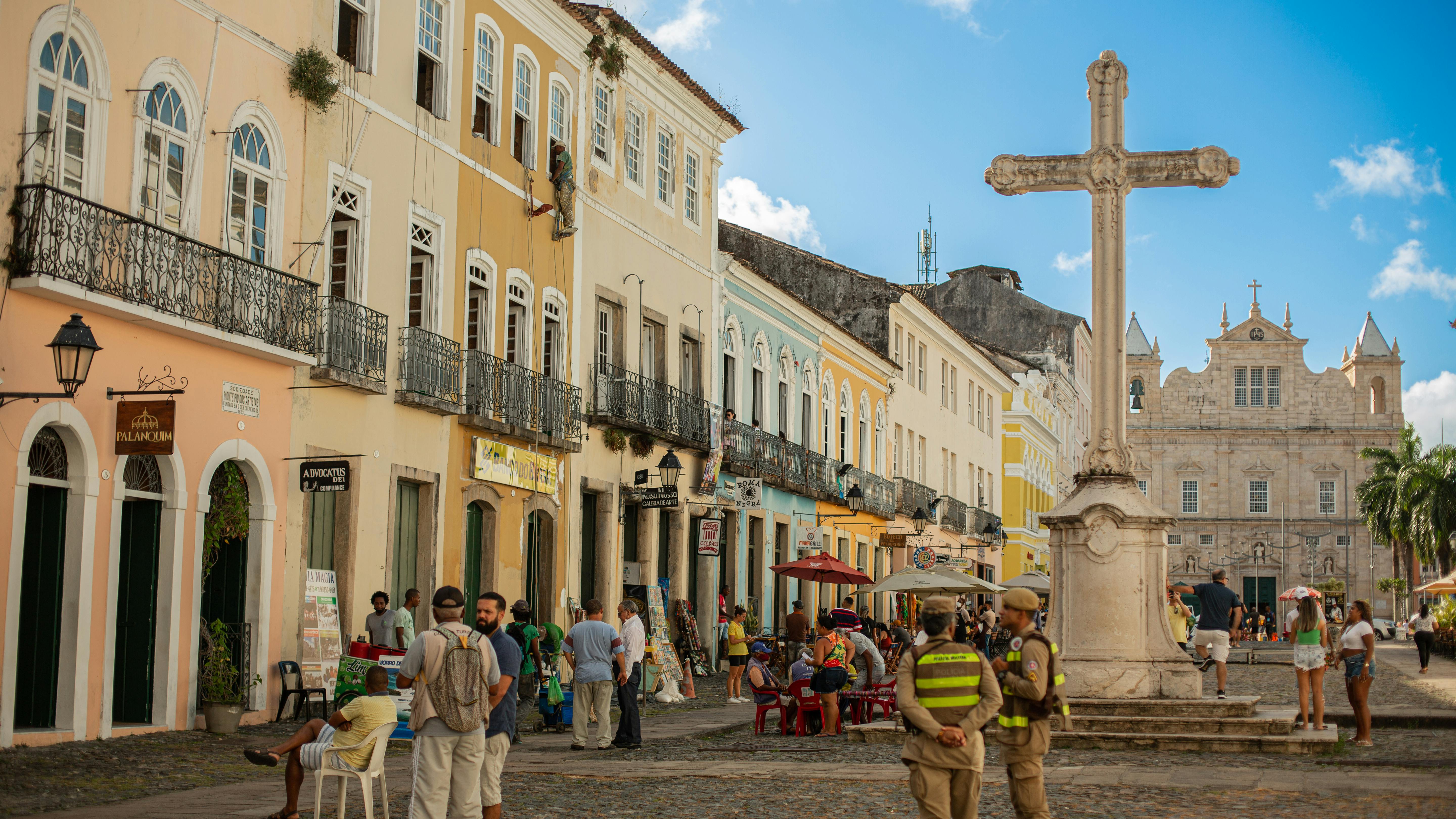 Explore the lively Pelourinho district in Salvador, showcasing colorful colonial architecture and bustling public square.
