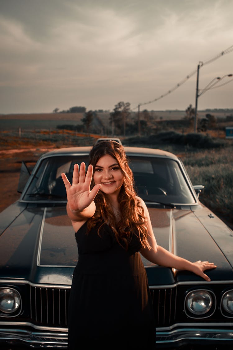 Smiling Woman In Front Of A Black Car