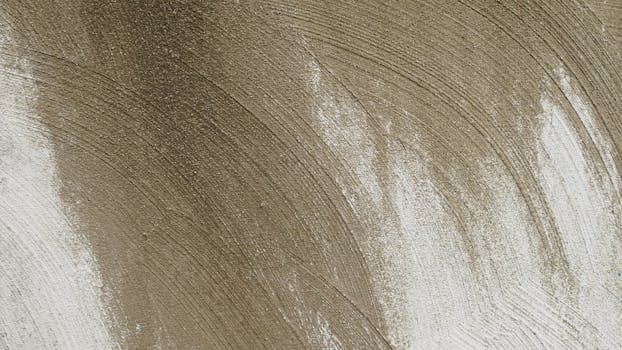 Close-up view of a rough concrete surface with distinctive swirling patterns for texture backgrounds.
